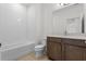 Clean bathroom with a tiled tub/shower combo, toilet, and modern vanity with brown cabinets at 2055 Town Pasture Dr, Eustis, FL 32726