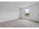 A bright bedroom with neutral carpeting and a window providing natural light at 2055 Town Pasture Dr, Eustis, FL 32726