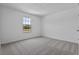 A bright and spacious bedroom with neutral carpeting and a large window overlooking a natural landscape at 2055 Town Pasture Dr, Eustis, FL 32726