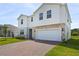 Attractive two-story home with a two-car garage and brick-paved driveway at 2055 Town Pasture Dr, Eustis, FL 32726