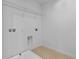 A small laundry room has tile flooring, white walls and a wire shelf at 2055 Town Pasture Dr, Eustis, FL 32726