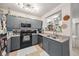 Cozy kitchen with gray cabinets, laminate countertops, stainless steel appliances and double sinks at 206 E South St # 3008, Orlando, FL 32801