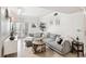 Comfortable living area with a gray sectional, a unique coffee table, and access to a balcony at 206 E South St # 3008, Orlando, FL 32801