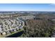 Panoramic aerial view highlighting a diverse residential area with homes nestled near a pond and wooded areas at 207 Black Springs Ln, Winter Garden, FL 34787