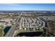 Attractive aerial view of neighborhood, showcasing homes with manicured lawns, water features, and road access at 207 Black Springs Ln, Winter Garden, FL 34787