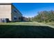 Spacious backyard with ample green space and the exterior of the home at 207 Black Springs Ln, Winter Garden, FL 34787