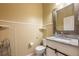 Bathroom with granite countertop vanity, stylish mirror, and white toilet at 207 Black Springs Ln, Winter Garden, FL 34787