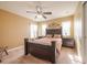 A spacious bedroom features a large bed, ceiling fan, and bright natural light at 207 Black Springs Ln, Winter Garden, FL 34787