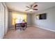 Bedroom features a desk, ceiling fan, and a mounted television set at 207 Black Springs Ln, Winter Garden, FL 34787