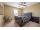 Bedroom with neutral carpet, ceiling fan, bright window, and comfortable bed at 207 Black Springs Ln, Winter Garden, FL 34787