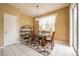 Cozy dining area with a glass table, contemporary lighting, and ample natural light at 207 Black Springs Ln, Winter Garden, FL 34787