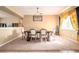 Bright dining room featuring a wooden table, chandelier, and large window at 207 Black Springs Ln, Winter Garden, FL 34787