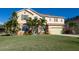 Beautiful two-story home with green shutters, a well-maintained lawn, and mature palm trees at 207 Black Springs Ln, Winter Garden, FL 34787