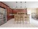 Well-appointed kitchen with stainless steel appliances, island seating, and tile floors at 207 Black Springs Ln, Winter Garden, FL 34787