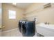 The laundry room features new washer and dryer units and a utility sink at 207 Black Springs Ln, Winter Garden, FL 34787