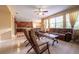 Open-concept living room connected to kitchen, featuring large windows, sofa, and tile floors at 207 Black Springs Ln, Winter Garden, FL 34787