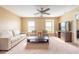 Living room with neutral carpet, ceiling fan, bright windows, and comfortable seating at 207 Black Springs Ln, Winter Garden, FL 34787