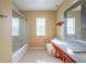 Bright main bathroom with shower and granite countertop at 207 Black Springs Ln, Winter Garden, FL 34787