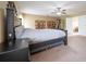 Bright main bedroom has large bed and exercise machine at 207 Black Springs Ln, Winter Garden, FL 34787