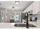 Modern kitchen with white cabinets and stainless steel appliances at 2112 Cypress Bay Blvd, Kissimmee, FL 34743
