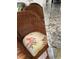 Close-up of a rattan bar stool with floral patterned seat cushion and granite countertop at 2348 Silver Palm, Kissimmee, FL 34747