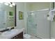 Bathroom with a glass-enclosed shower, vanity sink, and tropical-themed decorations at 2348 Silver Palm, Kissimmee, FL 34747