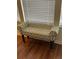 Comfortable bench with a palm tree pattern situated in front of a window with blinds at 2348 Silver Palm, Kissimmee, FL 34747