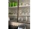 Kitchen cabinet displaying glasses, cups, and decorative items on shelves at 2348 Silver Palm, Kissimmee, FL 34747