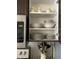 Cabinet featuring dishware and utensils next to a stainless steel microwave at 2348 Silver Palm, Kissimmee, FL 34747