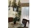 A dining room with a glass table, tropical centerpiece, and chandelier exudes island charm at 2348 Silver Palm, Kissimmee, FL 34747