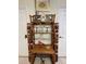 A decorative display shelf adorned with Tiki posts, colorful bird statues, pineapples, and glassware at 2348 Silver Palm, Kissimmee, FL 34747