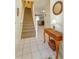 Bright foyer with neutral tile floors, staircase, and decorative table with mirror at 2348 Silver Palm, Kissimmee, FL 34747