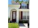 Inviting two-story home featuring a red front door with decorative windows and red shutters at 2348 Silver Palm, Kissimmee, FL 34747