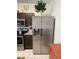 Spacious refrigerator in kitchen with brown cabinets and stainless steel appliances at 2348 Silver Palm, Kissimmee, FL 34747