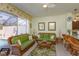 The living room boasts stylish wicker furniture and access to an outdoor pool at 2348 Silver Palm, Kissimmee, FL 34747