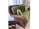 A wicker sofa with green cushions and decorative pillows provides comfortable seating at 2348 Silver Palm, Kissimmee, FL 34747