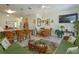 Open-concept living and dining area with kitchen bar, tile floors, and comfortable wicker furniture at 2348 Silver Palm, Kissimmee, FL 34747