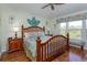 Bright main bedroom with wood floors, ceiling fan, and large windows offering outdoor views at 2348 Silver Palm, Kissimmee, FL 34747
