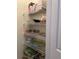 Pantry with wire shelving stocked with kitchenware, containers, and household items for organized storage at 2348 Silver Palm, Kissimmee, FL 34747