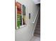 Hallway view showcasing 'Enchanted Tiki Room' artwork, a tiki mask, and a staircase at 2348 Silver Palm, Kissimmee, FL 34747