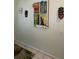 Hallway wall with an 'Enchanted Tiki Room' poster display, tropical rug, and a colorful mask at 2348 Silver Palm, Kissimmee, FL 34747