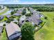 Scenic aerial view showcases a well-maintained neighborhood with green spaces and tree-lined streets on a sunny day at 2411 Sabastian St, Mount Dora, FL 32757