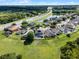 Expansive aerial view highlights the property's proximity to lush landscapes and a picturesque pond near the highway at 2411 Sabastian St, Mount Dora, FL 32757