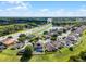 Birds eye view of the backyard pool surrounded by lush landscaping, a pond, and a nearby highway at 2411 Sabastian St, Mount Dora, FL 32757