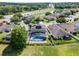 Beautiful aerial view of home featuring a screened pool, fenced yard, and solar panels in a lovely neighborhood at 2411 Sabastian St, Mount Dora, FL 32757