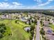 Broad aerial perspective displaying the community, complete with mature landscaping and a community pool at 2411 Sabastian St, Mount Dora, FL 32757