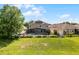 Exterior view of a home featuring a screened pool, solar panels and fenced yard at 2411 Sabastian St, Mount Dora, FL 32757