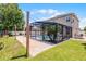 A stunning screened pool and patio area, enhanced by lush landscaping, string lights, and a well-maintained backyard at 2411 Sabastian St, Mount Dora, FL 32757