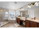 Elegant bathroom with dual vanities, a glass shower, and soaking tub at 2411 Sabastian St, Mount Dora, FL 32757