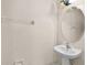 Powder room with pedestal sink, updated faucet, and decorative mirror with lighting at 2411 Sabastian St, Mount Dora, FL 32757